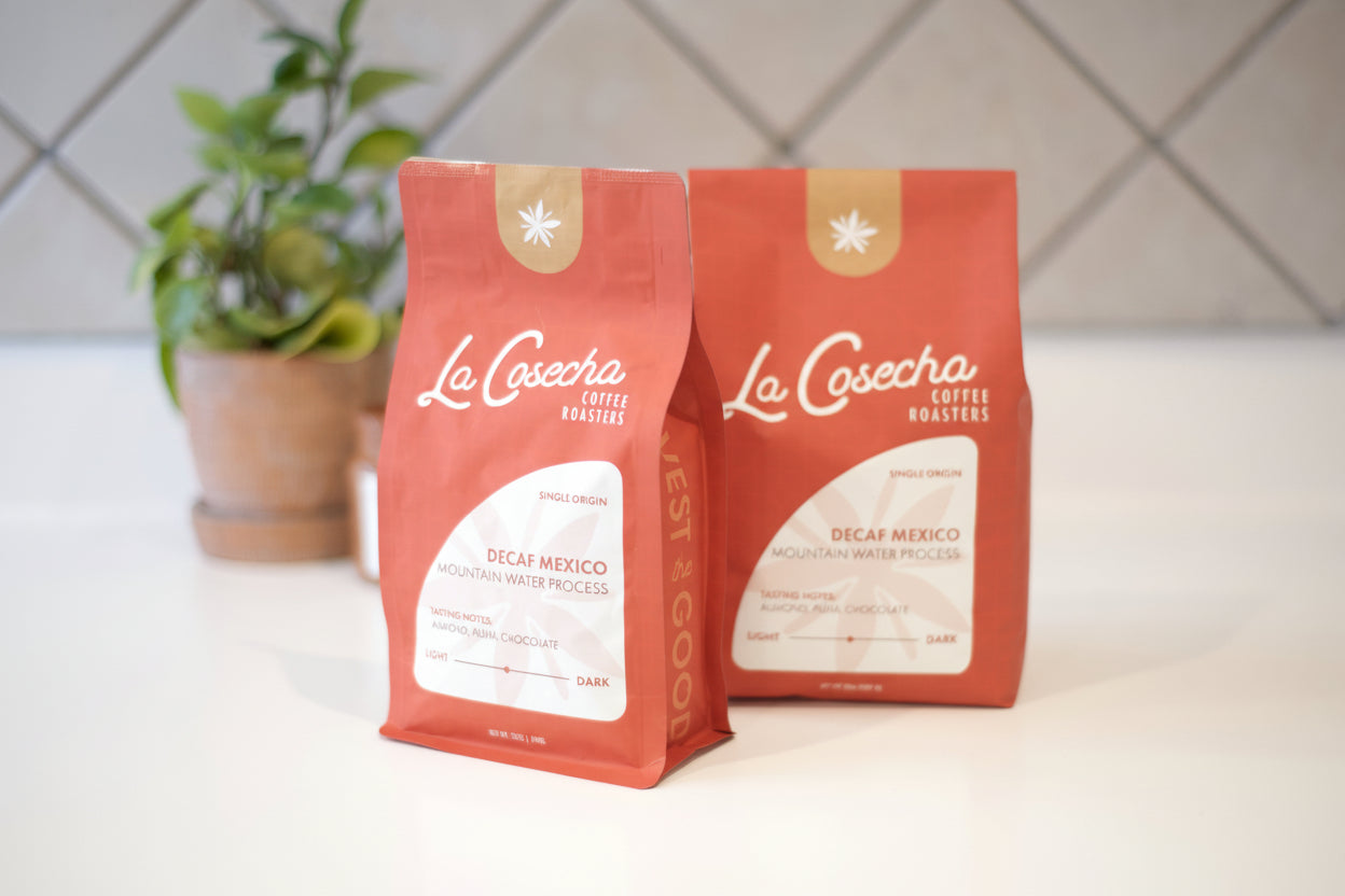 Two orange coffee bags with 'La Cosecha' branding on a white surface.
