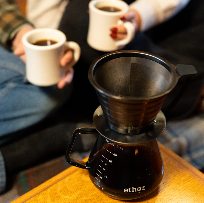 Ethoz coffee maker with two white mugs of coffee in the background