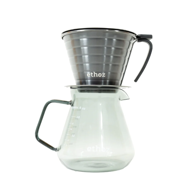 Clear glass coffee maker with metal funnel on a white background
