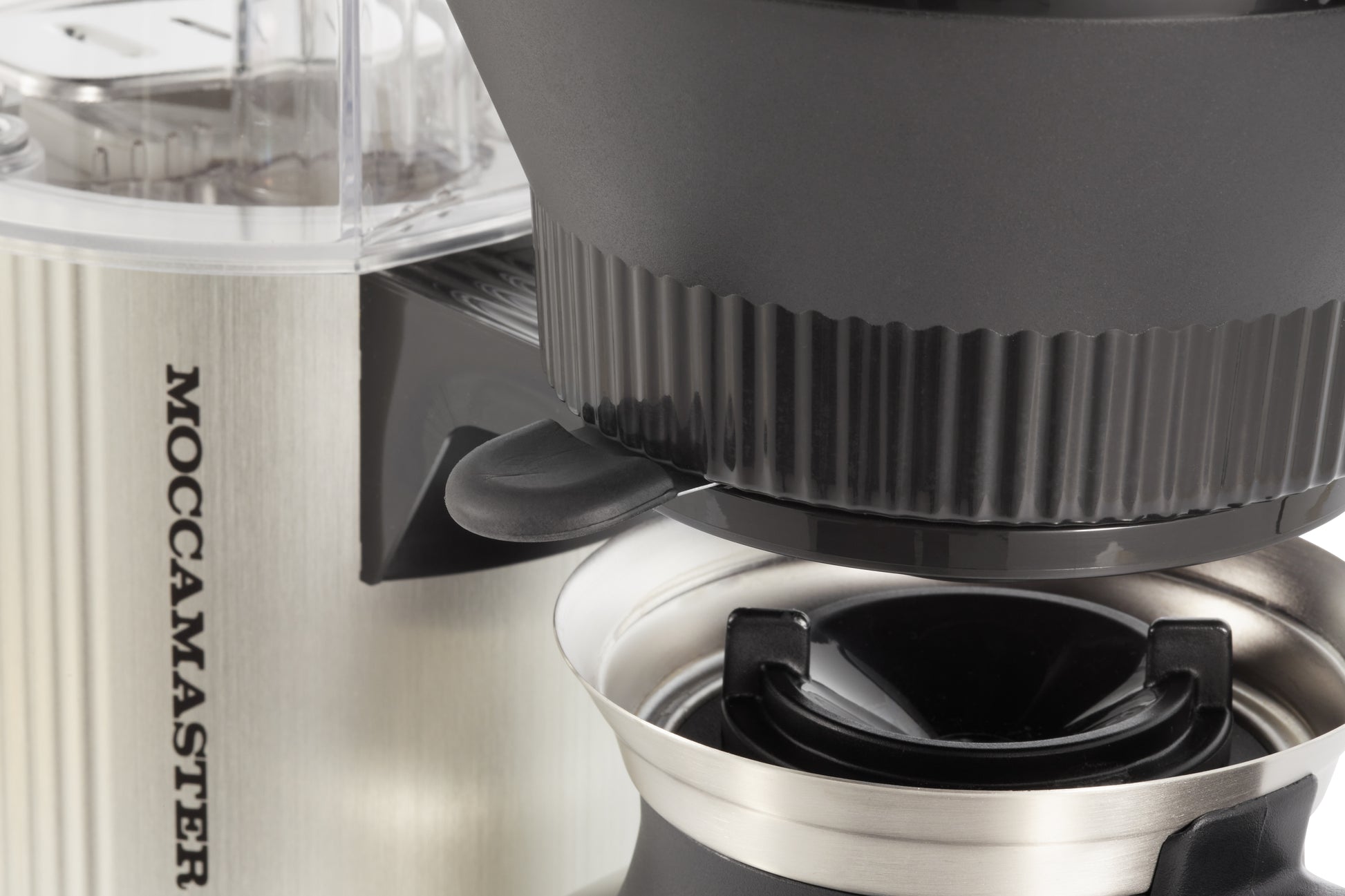 Close-up of a Moccamaster coffee maker with a focus on the brewing mechanism.