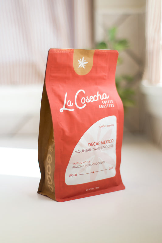 La Cosecha coffee bag on a white surface with a blurred background