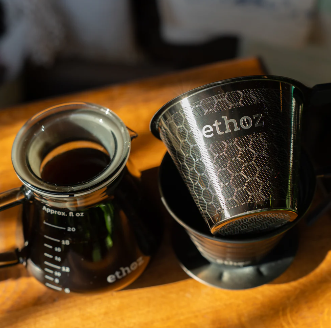 Ethoz coffee filter on a wooden surface with a blurred background