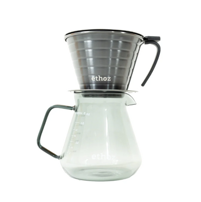 Clear glass coffee maker with metal funnel on a white background