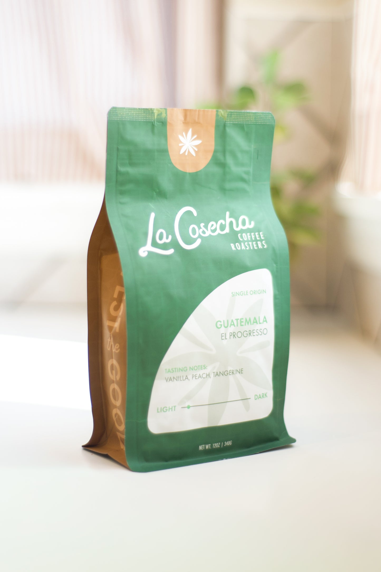 Green coffee bag with 'La Cosecha' branding on a light background