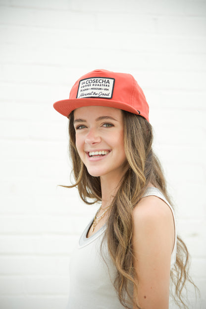 Woman wearing a orange cap with text on a white background