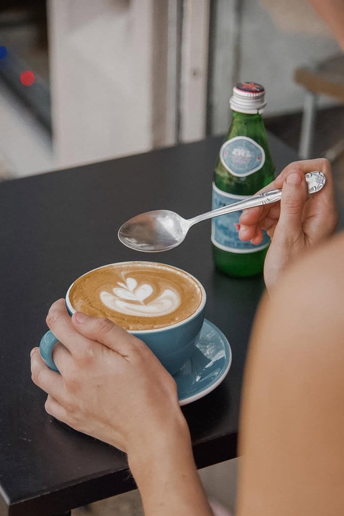 Drinking a latte outside.