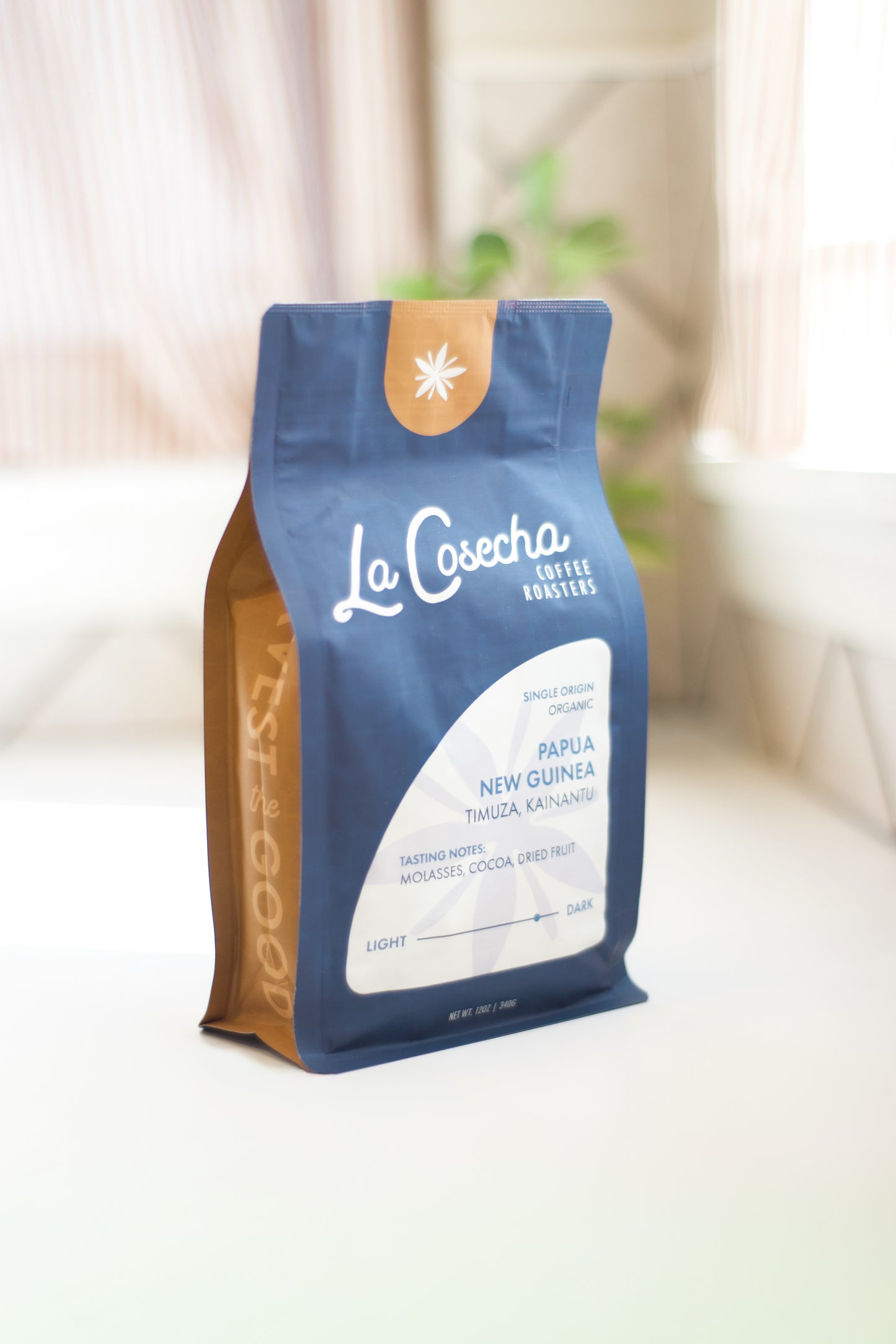 Le Cosecha Coffee bag on a white surface with a blurred background