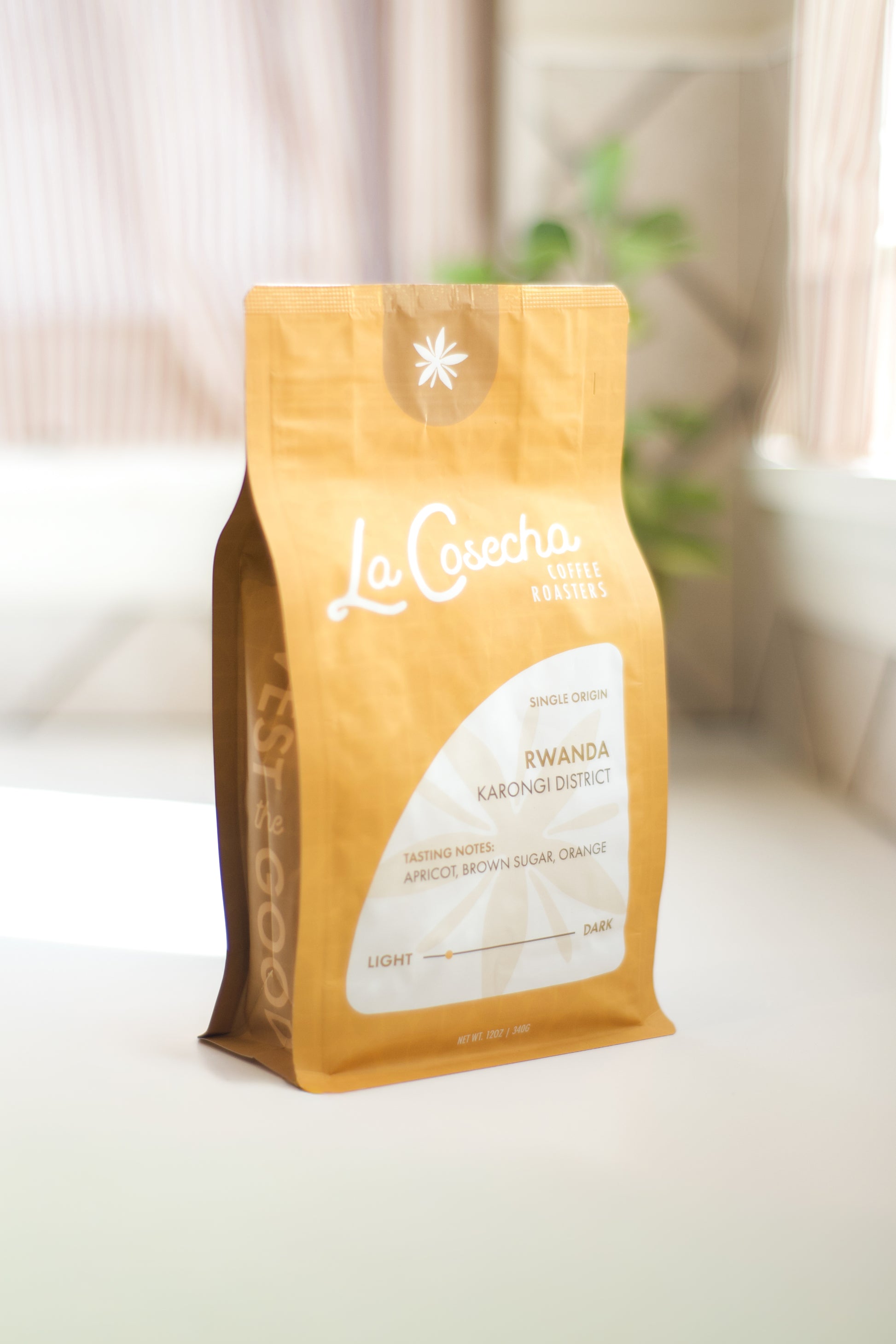 La Cosecha coffee bag on a white surface with a blurred background