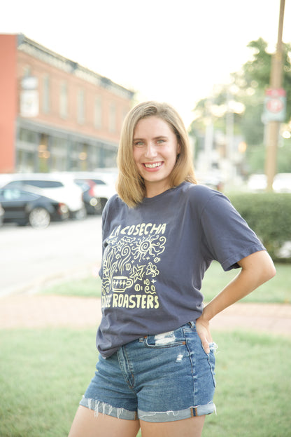 Woman wearing a navy Comfort Colors t-shirt with text and graphics, standing outdoors on a street.